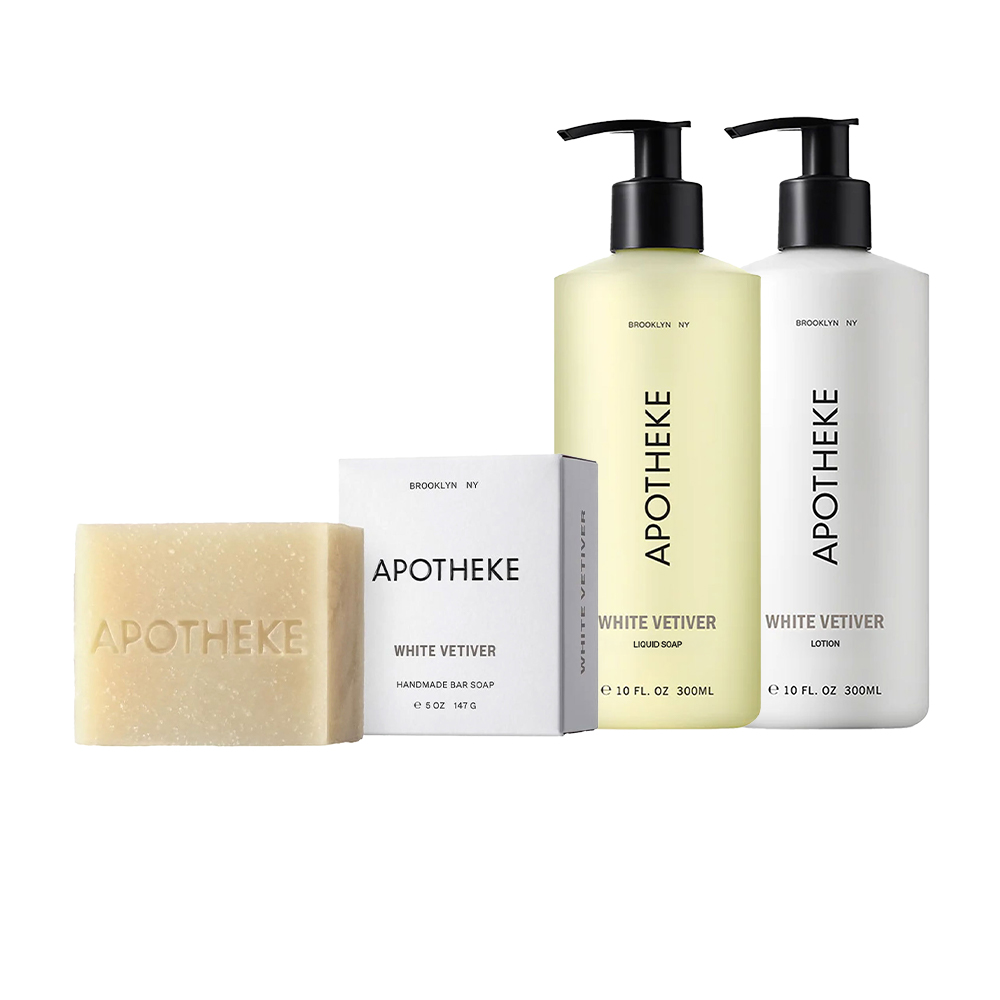 Apothek White Vetiver Room Spray, Sea Salt Grapefruit Candle, and Liquid Soap displayed on a minimal lifestyle table setting.