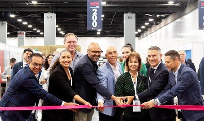 Group of travel industry executives participating in a ribbon-cutting ceremony at WTE Miami, symbolizing the show's growth and new acquisition by Fairfest Media.