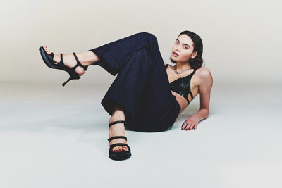 Model wearing the SNEEX Charlie Hy-Heel Sandal in a fashion-forward studio campaign showcasing the innovative summer Hy-Heel design.