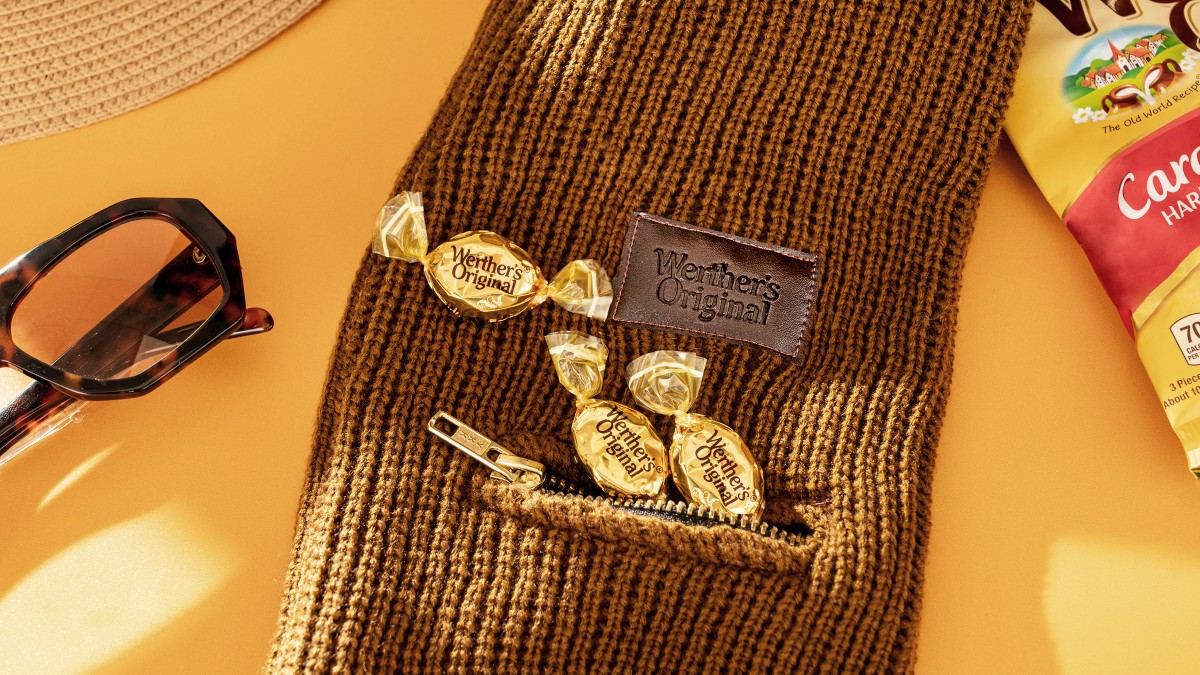 Werther’s Original hard caramel candies tucked inside a brown knit scarf pocket with sunglasses and fall accessories